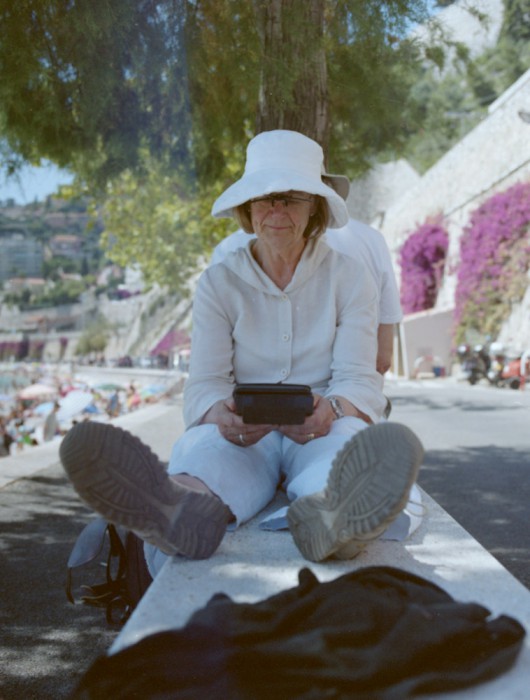 woman enjoying the sun with her kindle at the beach of Villefranche | by bertram rusch